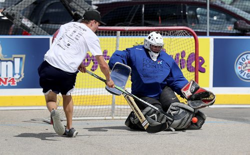 TREVOR HAGAN / WINNIPEG FREE PRESS Kyle Gallant makes a save for his team, Four Points by Sheraton Winnipeg South on a shot by Patrick Dawson of the True North Foundation team during the Play On 4 on 4 street hockey tournament at the University of Manitoba, Saturday, May 28, 2016.
