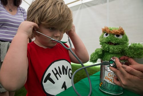 MIKE DEAL / WINNIPEG FREE PRESS Lucas James-Balan, 4, tries to listen to his Oscar stuffy while at the Teddy Bears Picnic at Assiniboine Park Sunday. 160529 - Sunday, May 29, 2016