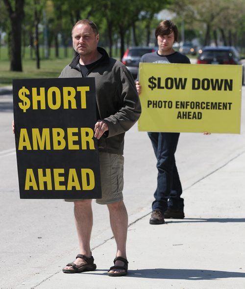 JOE BRYKSA / WINNIPEG FREE PRESS   WiseupWinnipeg leaders Todd Dube, left, and Chris Sweryde holding signs on the roadside in Winnipeg-May 30 , 2016.(see Gordon Sinclair story)