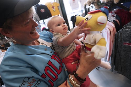 JOHN WOODS / WINNIPEG FREE PRESS Carole Bilyk with great niece Elizabeth Charbonneau and her new Goldie mascot toy at the Winnipeg Goldeyes home opener against the Sioux Falls Canaries Monday, May 30, 2016.