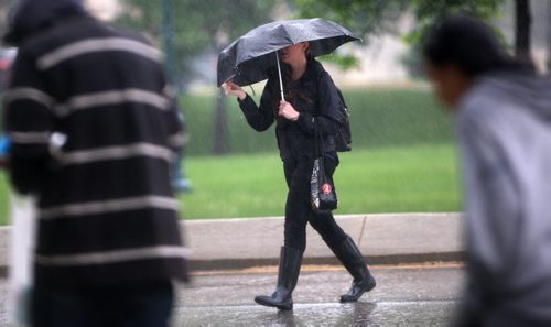 JOE BRYKSA / WINNIPEG FREE PRESS   Wet commute in Winnipeg this morning on Osborne St N near the great west Life buildings- Winnipeg will see rain over the city for most of the day as a huge Low is sweeping across Manitoba -May 31 , 2016.(Standup Photo)