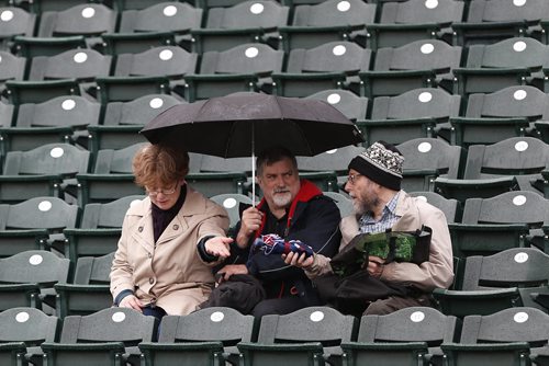 JOHN WOODS / WINNIPEG FREE PRESS Bev Phillips, Dave Barber and Howard Curl wonder if the game between the Winnipeg Goldeyes and Sioux Falls Canaries will be called off due to rain in Winnipeg Tuesday, May 31, 2016.