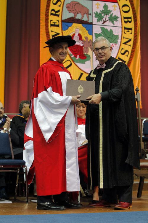 BORIS MINKEVICH / WINNIPEG FREE PRESS 2016 Spring Convocation, the University of Manitoba will confer degrees, diplomas and certificates on 3,040 graduates. This is the largest graduating class since 1977. During Convocation, honorary degrees are awarded for distinguished achievement. Candidates for honorary degrees are nominated by members of the University and the public. The 137th annual Spring Convocation of the University of Manitobain the Investors Group Athletic Centre (IGAC) Gerald Schwartz, left, received an Honorary Doctor of Laws. U of M President David Barnard, right, presenting it. June 1, 2016.
