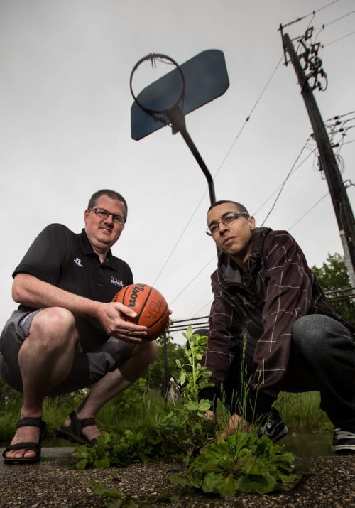 MIKE DEAL / WINNIPEG FREE PRESS Eric Edwards (right) and Basketball Manitoba director Adam Wedlake (left) at a derelict basketball court on Cumberland  one of five that Edwards has taken the initiative, along with Wedlake and a call-out to volunteers  to clean up and add nets to. 160601 - Wednesday, June 01, 2016