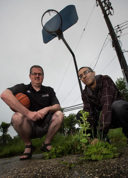 MIKE DEAL / WINNIPEG FREE PRESS Eric Edwards (right) and Basketball Manitoba director Adam Wedlake (left) at a derelict basketball court on Cumberland  one of five that Edwards has taken the initiative, along with Wedlake and a call-out to volunteers  to clean up and add nets to. 160601 - Wednesday, June 01, 2016