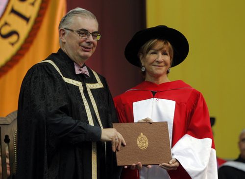 BORIS MINKEVICH / WINNIPEG FREE PRESS 2016 Spring Convocation, the University of Manitoba will confer degrees, diplomas and certificates on 3,040 graduates. This is the largest graduating class since 1977. During Convocation, honorary degrees are awarded for distinguished achievement. Candidates for honorary degrees are nominated by members of the University and the public. The 137th annual Spring Convocation of the University of Manitoba in the Investors Group Athletic Centre (IGAC) Heather Reisman, right, received an Honorary Doctor of Laws. U of M President David Barnard, left, presenting it. June 1, 2016.