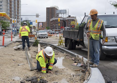 ZACHARY PRONG / WINNIPEG FREE PRESS  (R-L) Construction workers Manuel Gomes, Jose Felegueyras and Manuel Rego at work on Portage Ave. Customers and business owners have been frustrated by constant construction in the area. June 1, 2016.