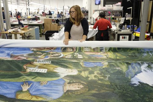 ZACHARY PRONG / WINNIPEG FREE PRESS  Brandi Hutlet rolls up a reproduction of artwork from the Sistine Chapel for shipment to Mexico City at Valley Fashions on Monday, May 30, 2016.