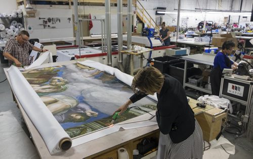 ZACHARY PRONG / WINNIPEG FREE PRESS  Alex Vanderhooft and Dan Coates trim a reproduction of artwork from the Sistine Chapel at Valley Fashions on Monday, May 30, 2016.