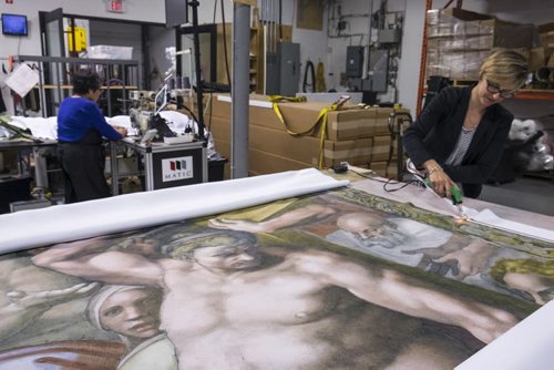 ZACHARY PRONG / WINNIPEG FREE PRESS  Alex Vanderhooft trims a reproduction of artwork from the Sistine Chapel at Valley Fashions on Wednesday, June 1, 2016.