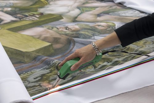 ZACHARY PRONG / WINNIPEG FREE PRESS  Alex Vanderhooft trims a reproduction of artwork from the Sistine Chapel at Valley Fashions on Wednesday, June 1, 2016.