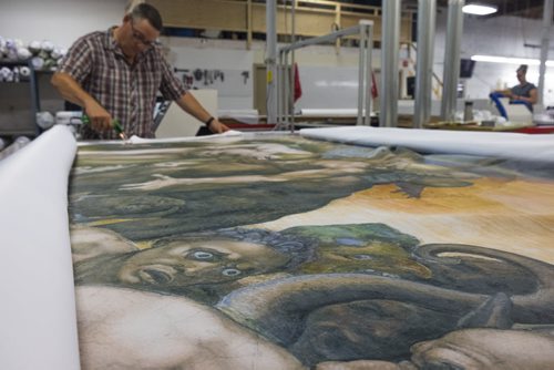 ZACHARY PRONG / WINNIPEG FREE PRESS  Dan Coates trims a reproduction of artwork from the Sistine Chapel at Valley Fashions on Wednesday June 1, 2016.