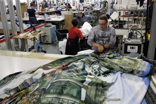 ZACHARY PRONG / WINNIPEG FREE PRESS  Dan Coates folds one of the reproductions of art from the Sistine Chapel on May 30, 2016.