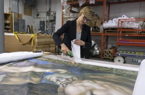 ZACHARY PRONG / WINNIPEG FREE PRESS  Alex Vanderhooft trims a reproduction of artwork from the Sistine Chapel at Valley Fashions on Wednesday, June 1, 2016.