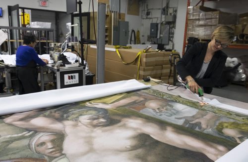 ZACHARY PRONG / WINNIPEG FREE PRESS  Alex Vanderhooft trims a reproduction of artwork from the Sistine Chapel at Valley Fashions on Wednesday, June 1, 2016.