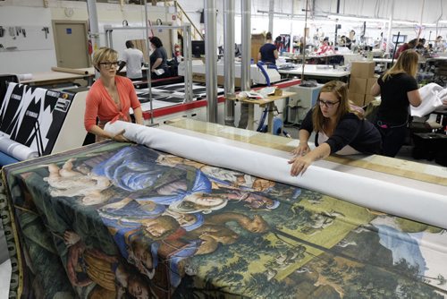 ZACHARY PRONG / WINNIPEG FREE PRESS  Alex Vanderhooft and Brandi Hutlet roll up a reproduction of artwork from the Sistine Chapel for shipment to Mexico City at Valley Fashions on Monday, May 30, 2016.