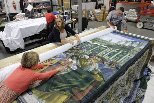 ZACHARY PRONG / WINNIPEG FREE PRESS  Alex Vanderhooft, Brandi Hutlet and Dan Coates roll up a reproduction of artwork from the Sistine Chapel for shipment to Mexico City at Valley Fashions on Monday, May 30, 2016.