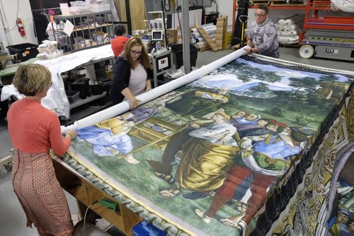 ZACHARY PRONG / WINNIPEG FREE PRESS  Alex Vanderhooft, Brandi Hutlet and Dan Coates roll up a reproduction of artwork from the Sistine Chapel for shipment to Mexico City at Valley Fashions on Monday, May 30, 2016.