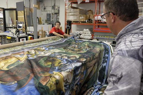 ZACHARY PRONG / WINNIPEG FREE PRESS  Diana Perez and Dan Coates put final touches on a reproduction of artwork from the Sistine Chapel Valley Fashions on Monday, May 30, 2016.