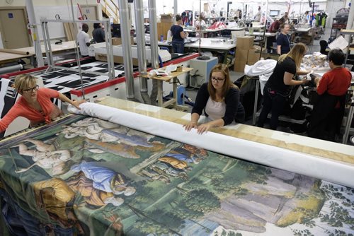 ZACHARY PRONG / WINNIPEG FREE PRESS  Alex Vanderhooft and Brandi Hutlet roll up a reproduction of artwork from the Sistine Chapel for shipment to Mexico City at Valley Fashions on Monday, May 30, 2016.