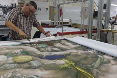 ZACHARY PRONG / WINNIPEG FREE PRESS  Dan Coates trims a reproduction of artwork from the Sistine Chapel at Valley Fashions on Wednesday, June 1, 2016.