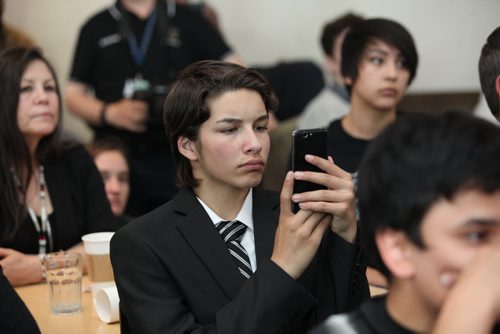 RUTH BONNEVILLE / WINNIPEG FREE PRESS  Austin Semko,  a student at Children of the Earth School listens to Prime Minister Justin Trudeau being interviewed by WFP Editor Paul Samyn while video taping it on his phone at the Winnipeg Free Press News Cafe Thursday.  June 02 / 2016