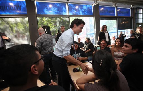 RUTH BONNEVILLE / WINNIPEG FREE PRESS  Prime Minister Justin Trudeau shakes hands with students from Children of the Earth high school at the Winnipeg Free Press News Cafe after being interviewed by WFP editor Paul Samyn Thursday.  June 02 / 2016