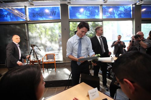 RUTH BONNEVILLE / WINNIPEG FREE PRESS   Prime Minister Justin Trudeau receives gifts from students from  Children of the Earth School  at the Winnipeg Free Press News Cafe Thursday.  June 02 / 2016