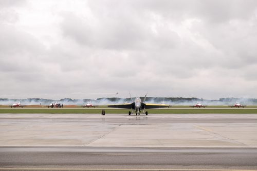 ZACHARY PRONG / WINNIPEG FREE PRESS  A CF-18 Hornet and Snowbirds sit on the runway at Southport Airfield on Friday, June 3, 2016, as Brett Handy, a Snowbirds trainer, flies his personal stunt plane in the background.