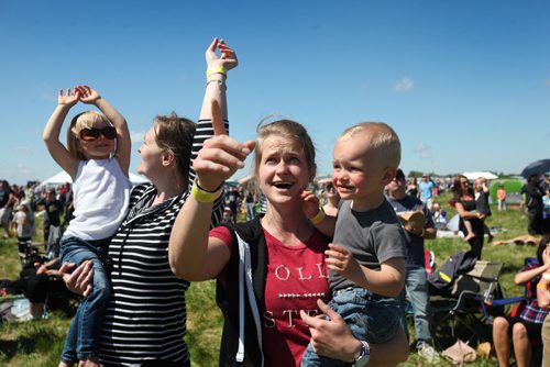 RUTH BONNEVILLE / WINNIPEG FREE PRESS  Maggie Neumann holds her nephew Caleb (2yrs) while her sister Nelli Neumann holds her niece Talia (3yrs), (cousins) while being wowed by a F18 fly-over at the Manitoba Air Show in Southport near Portage Saturday.  See Kevin's story.    June 04 / 2016