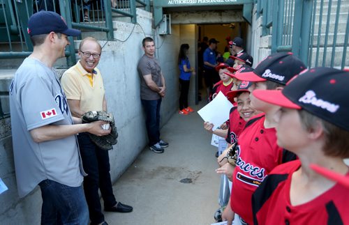 TREVOR HAGAN / WINNIPEG FREE PRESS Mayor Brian Bowman speaks with former mayor Sam Katz before he threw out the ceremonial pitch prior to the Goldeyes game on Diversity Day at Shaw Park, Saturday, June 4, 2016.