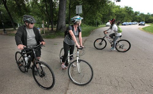 PHIL HOSSACK / WINNIPEG FREE PRESS -  Cyclists Wayne Hewitt and friend Janice (she didn't want her last name used) watch a helmetless cyclist speed past across traffic in Assiniboine Park. See Alex Paul's story.  June 6, 2016