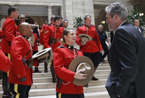 WAYNE GLOWACKI / WINNIPEG FREE PRESS       Premier Brian Pallister speaks to RCMP Const. Sabrina Whall before the group photo with members of the RCMP "D" Division who attended the Order of the Buffalo Hunt ceremony in the Manitoba Legislative Bld. Tuesday.  A total of 65 RCMP members were deployed to Fort McMurray at the height of the wildfires.  The Order of the Buffalo Hunt is the highest honour the province can bestow to individuals who have demonstrated outstanding skills in the areas of leadership, service and community commitment. Aidan Geary story.   June 7  2016