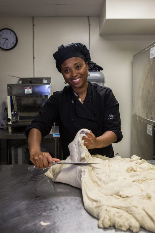MIKE DEAL / WINNIPEG FREE PRESS Demi Akindipe prepares their special bread. Bryan and Temi Akindipe (pictured) are both from Nigeria - they met in Winnipeg about 10 years ago, while studying nursing at U of M. After getting married, Bryan missed the Agege bread he grew up with in Nigeria so he started fooling around in the kitchen, trying to recreate the bread his grandmother used to make. After nailing it, friends and family told him he should market it - not only to ex-pat Africans but Canadians, too. So he and his wife opened their own place in February, Arabelle's Bakery, 1284 Archibald Street. 160607 - Tuesday, June 07, 2016