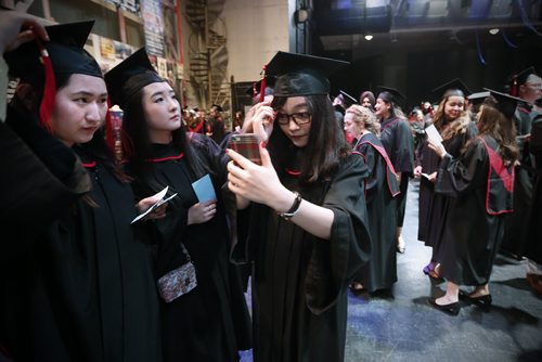 JOHN WOODS / WINNIPEG FREE PRESS Serena Chen, Maryanne Li, and Erin Chang put the finishing touches backstage prior to the Red River College spring convocation ceremony at the Centennial Concert Hall Tuesday, June 7, 2016.