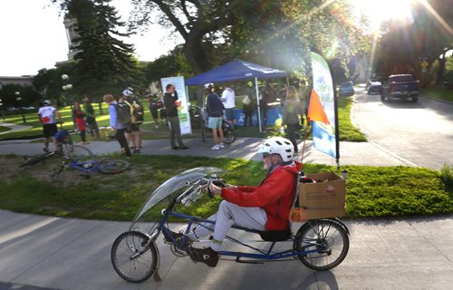WAYNE GLOWACKI / WINNIPEG FREE PRESS      Victor Bock takes off on his recumbent bicycle after enjoying a free coffee and cinnamon bun to celebrate Clean Air Day Wednesday morning. A tent on Osborne St. at Assiniboine Ave. was set up by the Green Action Centre as part of the the national Commuter Challenge to celebrate active commuters that walk,run, bike, or rolling of any other kind with free coffee and cinnamon bun on their way to work.   see release.  June 8  2016