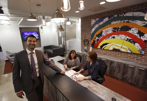 WAYNE GLOWACKI / WINNIPEG FREE PRESS      Roy Sandhawalia, Area Manager with staff Jodi Sheppard and Wenda Lee Cameron,right, in the reception area at the new Regus workspace at 330 St. Mary Avenue. Bailey Hildebrand story. June 8  2016