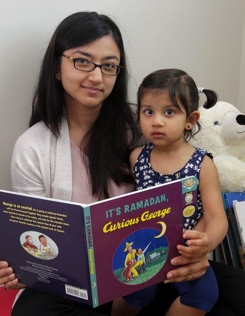 BORIS MINKEVICH / WINNIPEG FREE PRESS Writer of new book It's Ramadan, Curious George visits Winnipeg. Story ledes with local mother thrilled that she can read a book about her own culture and faith to her young daughter to explain Ramadan. Mother Taj Shakir-Farooqui and her daughter Zoya, 2, read the new Ramadan book.  June 10, 2016.