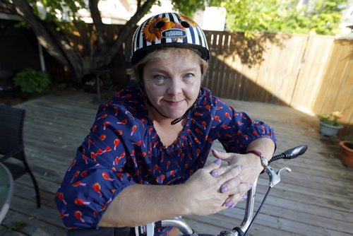 BORIS MINKEVICH / WINNIPEG FREE PRESS Winnipeg Free Press reporter Carol Sanders wrote a column on bike helmet issue. Here she poses for a photo with her bike and bike helmet.  June 10, 2016.