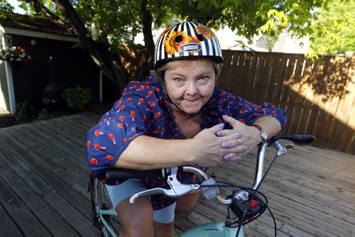 BORIS MINKEVICH / WINNIPEG FREE PRESS Winnipeg Free Press reporter Carol Sanders wrote a column on bike helmet issue. Here she poses for a photo with her bike and bike helmet.  June 10, 2016.