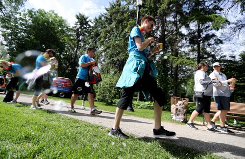 TREVOR HAGAN / WINNIPEG FREE PRESS Kati Sidwall walks through bubbles at a checkpoint in Munson Park during the CancerCare Manitoba Challenge for Life 2.0, Saturday, June 11, 2016.