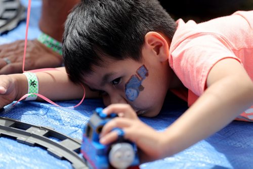 TREVOR HAGAN / WINNIPEG FREE PRESS Jonah Sumner-Peebles, 4, playing with a Thomas the Tank Engine Lego set at Kids Fest at The Forks, Saturday, June 11, 2016.