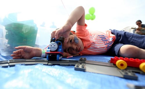 TREVOR HAGAN / WINNIPEG FREE PRESS Jonah Sumner-Peebles, 4, playing with a Thomas the Tank Engine Lego set at Kids Fest at The Forks, Saturday, June 11, 2016.