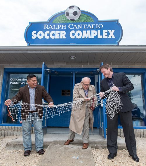 MIKE DEAL / WINNIPEG FREE PRESS Ralph Cantafio prepares to cut a soccer net to officially rename the Winnipeg Waverley Soccer Complex to the Ralph Cantafio Soccer Complex in his honour Sunday morning. He is flanked by Winnipeg City Councillor Mike Pagtakhan (left) and Matthew Duffy with the Winnipeg Soccer Federation (right). 160612 - Sunday, June 12, 2016