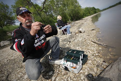 JOHN WOODS / WINNIPEG FREE PRESS Wayne Shushkewich baits his hook as his friend Heather Lavallee waits for a bite as they fish on the Red River during free fishing weekend Sunday, June 12, 2016.