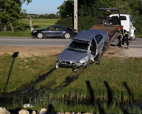 BORIS MINKEVICH / WINNIPEG FREE PRESS MVC into ditch a the end of Grassie Blvd. where it hits Plessis Road.  Car getting loaded onto a tow truck. June 13, 2016.