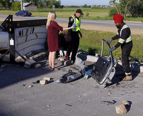 BORIS MINKEVICH / WINNIPEG FREE PRESS MVC into ditch a the end of Grassie Blvd. where it hits Plessis Road. Local business people talk to cops as tow truck driver hauls away debris. June 13, 2016.