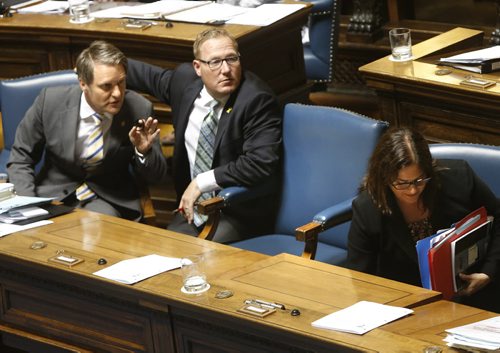 WAYNE GLOWACKI / WINNIPEG FREE PRESS     Scott Fielding, Minister of Families leans against the arm of Premier Brian Pallister's empty chair listening to Cameron Friesen Minister of Finance at the conclusion of question period Monday. At right is Heather Stefanson, Minister of Justice and Attorney General.  Kristin Annable story    June 13  2016