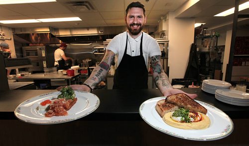 PHIL HOSSACK / WINNIPEG FREE PRESS - Chef and owner Adam Donnelly lens out of the open style kitchen with handfulls of Smoked Arctic Char and Turkish Eggs Turkish Eggs(right) at the eccentrically decorated Clementine Cafe.See Review.  June 13, 2016
