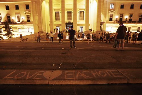 JOHN WOODS / WINNIPEG FREE PRESS The remaining few people take time in front of  the names of the Orlando shooting victims  on the steps of the Manitoba Legislature Monday, June 13, 2016.